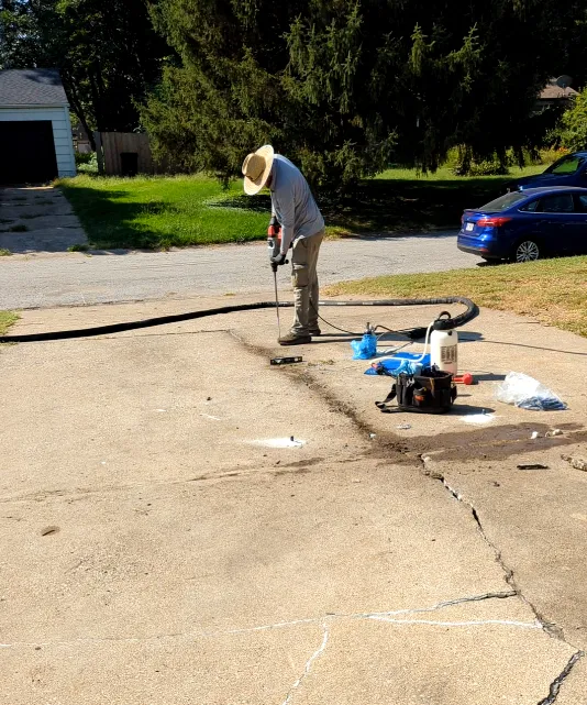 KC Lift & Level drilling an injection point in the driveway